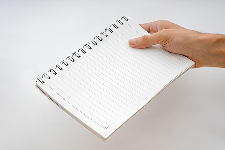 person holding notebook